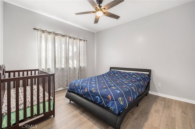 bedroom featuring hardwood / wood-style flooring and ceiling fan