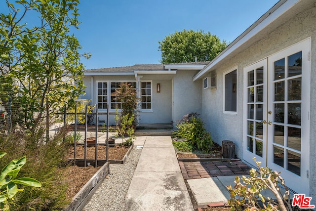 view of exterior entry featuring a patio area