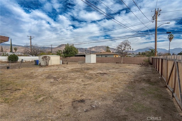 view of yard with a storage shed and a mountain view