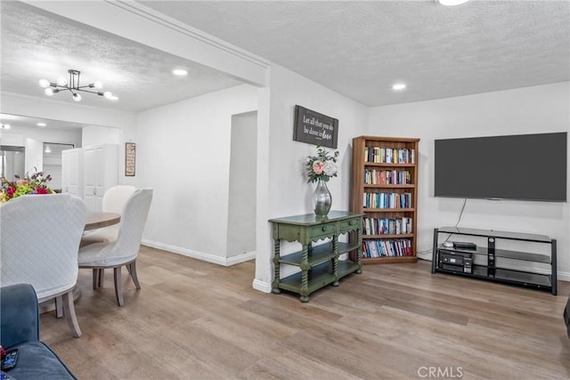 interior space featuring a chandelier, a textured ceiling, and light hardwood / wood-style flooring