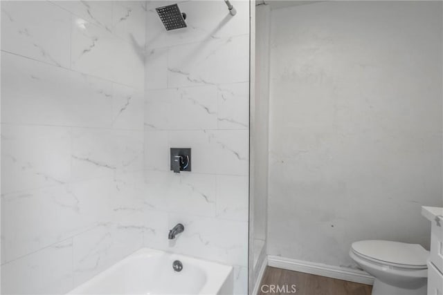 full bathroom featuring vanity, toilet, tiled shower / bath combo, and wood-type flooring