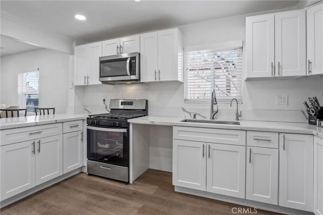 kitchen featuring white cabinetry, sink, stainless steel appliances, and dark hardwood / wood-style floors