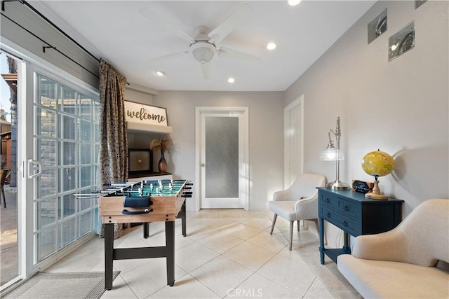 game room featuring french doors, ceiling fan, and light tile patterned flooring