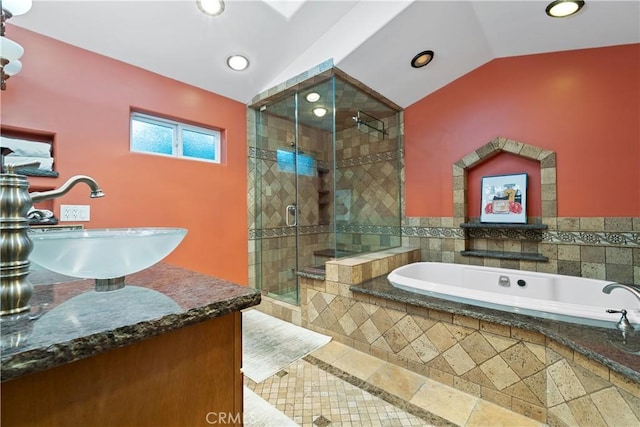 bathroom featuring lofted ceiling, sink, and separate shower and tub