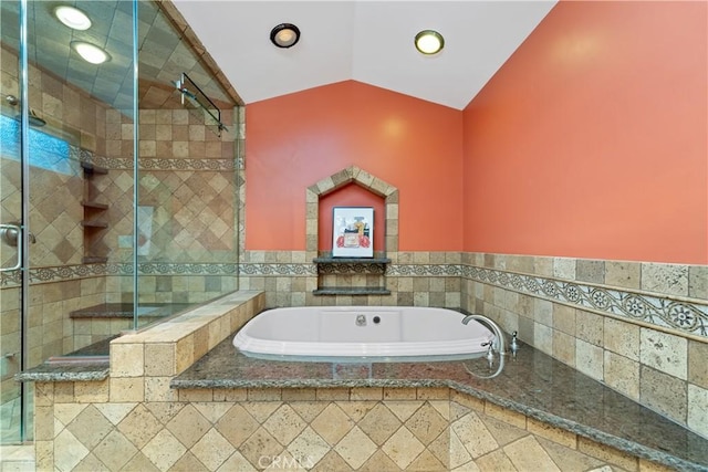 bathroom featuring lofted ceiling and separate shower and tub