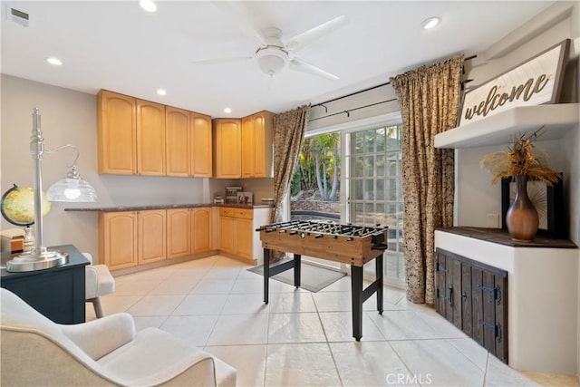 kitchen featuring light tile patterned flooring, ceiling fan, and light brown cabinets