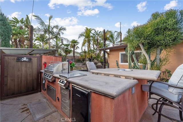 view of patio featuring area for grilling and exterior kitchen