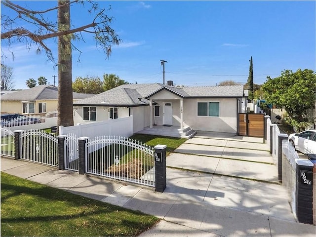 ranch-style home with a fenced front yard, a gate, and stucco siding