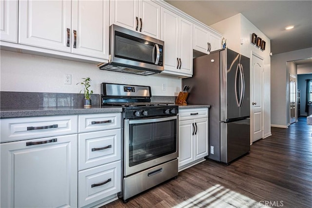 kitchen with stainless steel appliances, dark hardwood / wood-style floors, and white cabinets