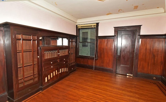 interior space featuring crown molding, elevator, and wood-type flooring