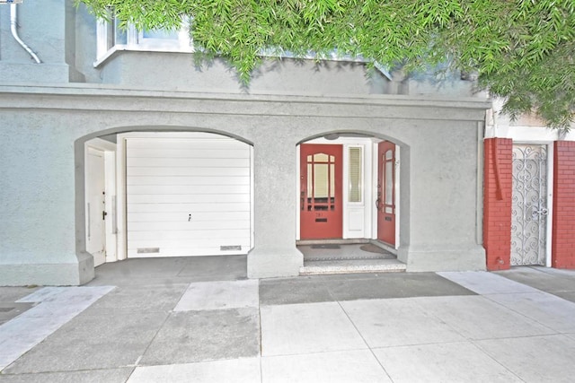 doorway to property with a garage