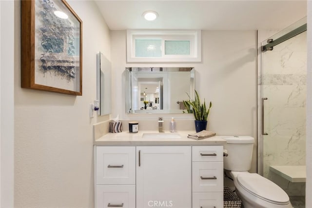 bathroom with vanity, toilet, and walk in shower