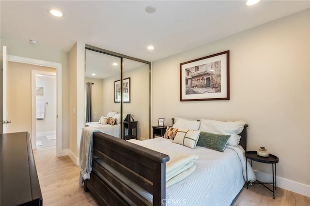 bedroom with a closet and light hardwood / wood-style flooring