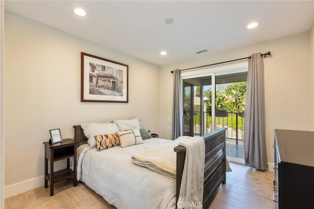 bedroom featuring light wood-type flooring and access to outside