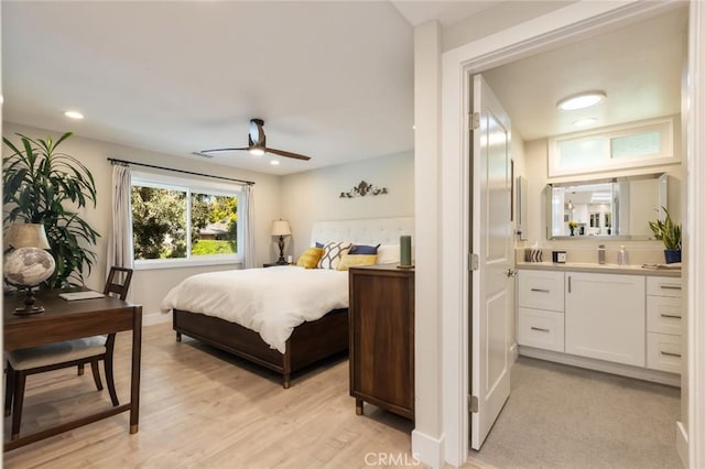 bedroom featuring ensuite bathroom, ceiling fan, and light hardwood / wood-style floors