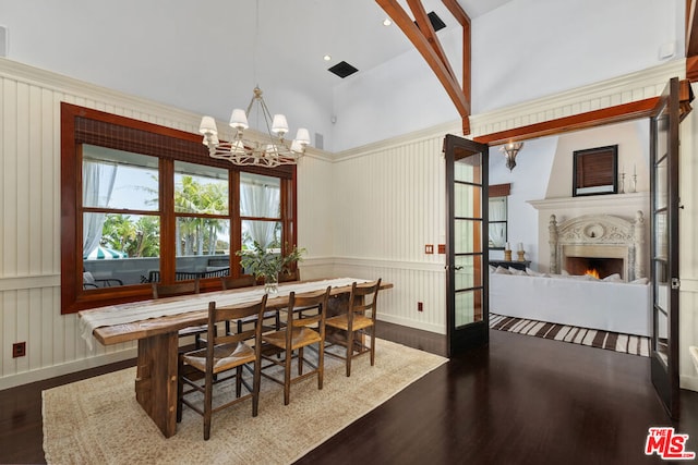 dining room with hardwood / wood-style floors, a fireplace, and a chandelier