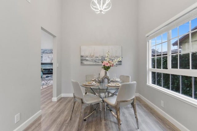 dining area with a notable chandelier and light wood-type flooring