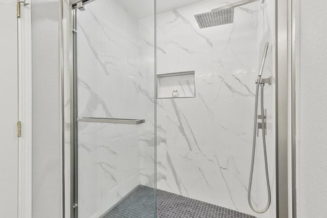 bathroom featuring a shower with shower door