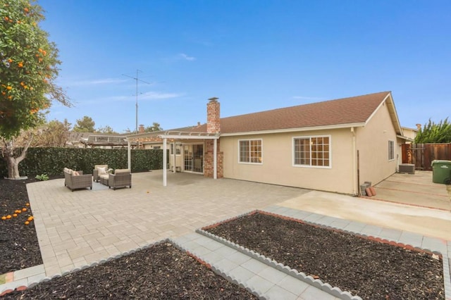 rear view of house featuring an outdoor living space, a patio, and central AC