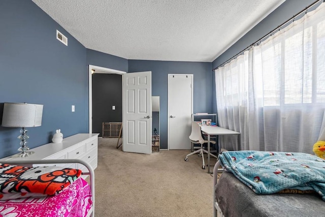 carpeted bedroom featuring a textured ceiling