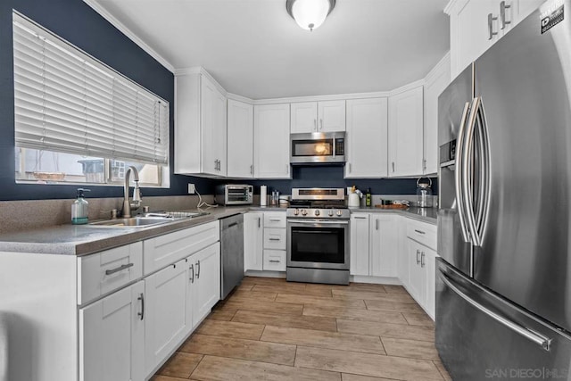 kitchen with sink, stainless steel appliances, and white cabinets