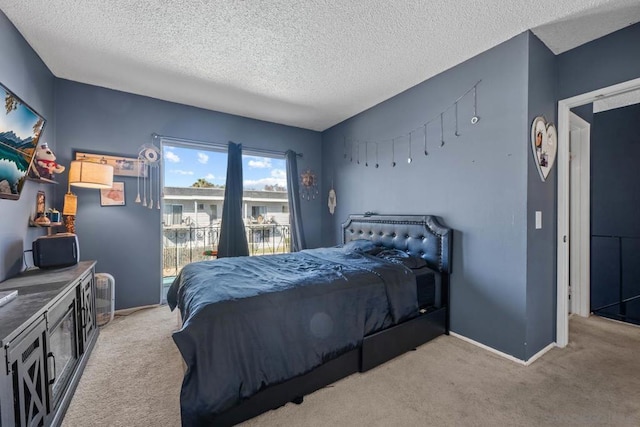 bedroom with light colored carpet and a textured ceiling