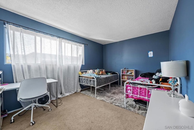 bedroom with carpet and a textured ceiling