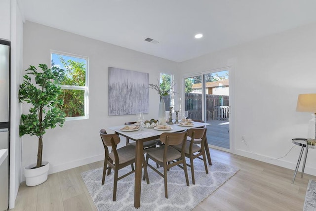 dining space featuring light wood-type flooring