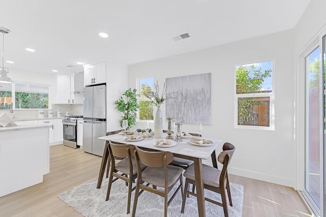 dining space with light wood-type flooring