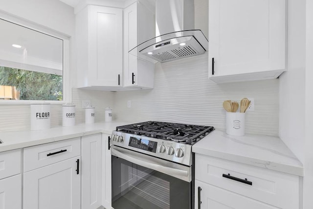 kitchen with white cabinetry, extractor fan, decorative backsplash, and gas stove