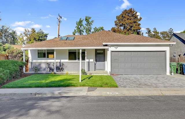 single story home with a garage, covered porch, and a front lawn