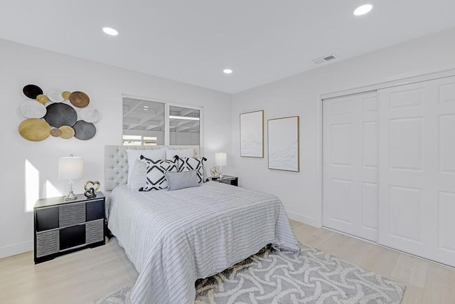 bedroom with a closet and light hardwood / wood-style flooring