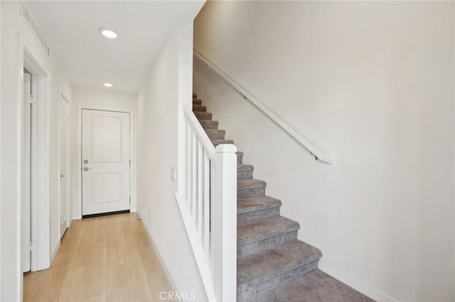 staircase with hardwood / wood-style flooring