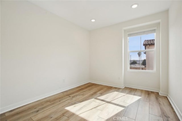 spare room with light hardwood / wood-style floors