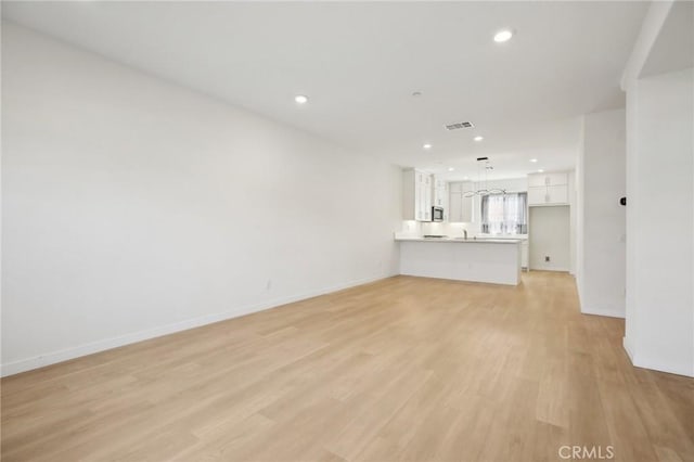 unfurnished living room featuring light wood-type flooring