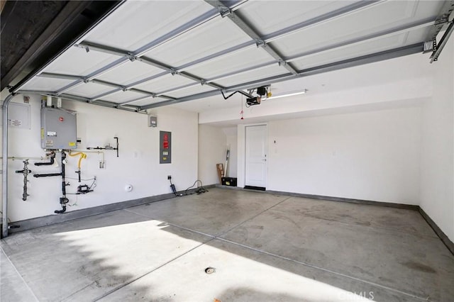 garage with a garage door opener, electric panel, and water heater