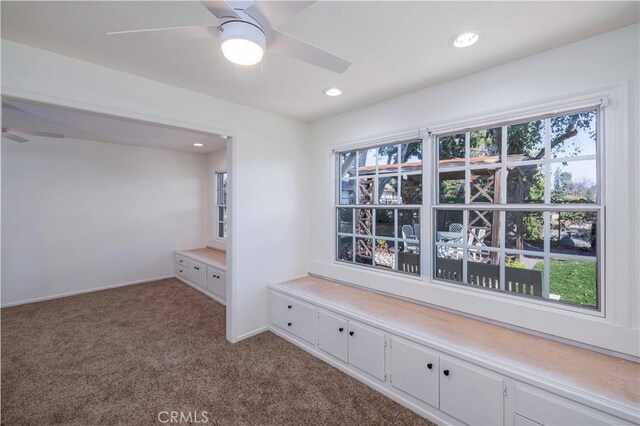 hall with light colored carpet and a healthy amount of sunlight