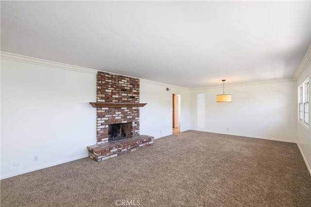 unfurnished living room featuring crown molding, carpet, and a fireplace