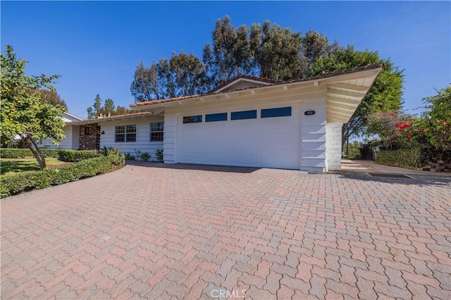 ranch-style house featuring a garage