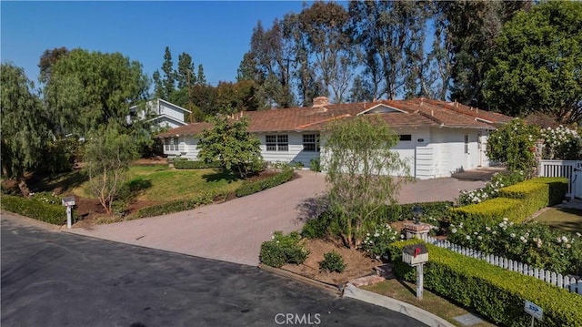 single story home with a garage and a front lawn