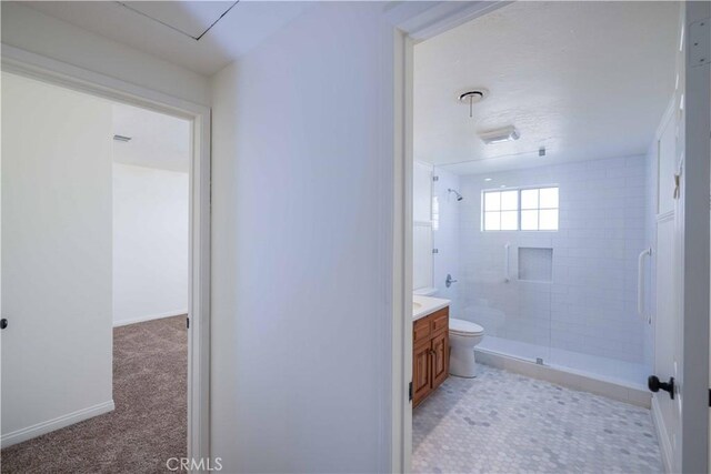 bathroom with vanity, a shower with door, and toilet