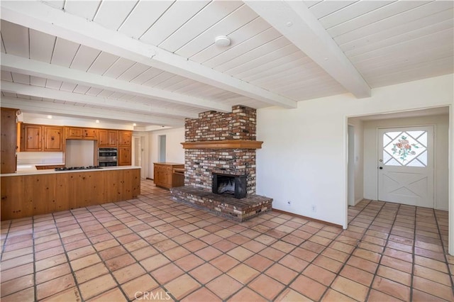 unfurnished living room featuring light tile patterned flooring, a brick fireplace, wooden ceiling, and beam ceiling