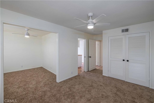 unfurnished bedroom featuring ceiling fan, carpet floors, and a closet