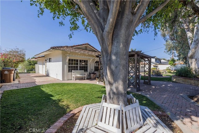 rear view of house featuring a patio and a lawn