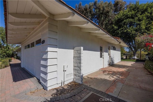 view of side of home with a garage