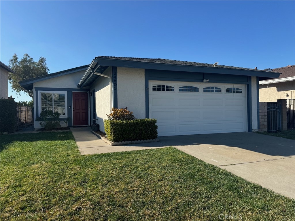 view of front of property with a garage and a front yard