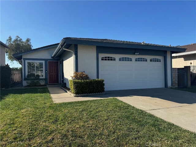 view of front of property with a garage and a front lawn