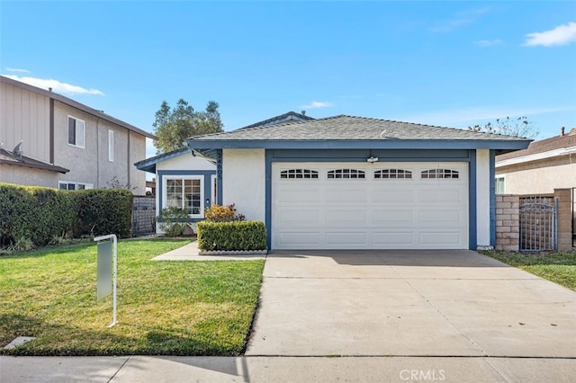 view of front of property with a garage and a front lawn