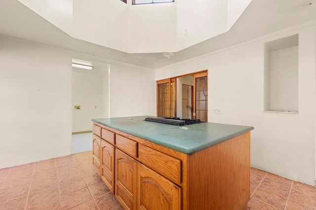 kitchen featuring light tile patterned floors, black gas stovetop, and a center island