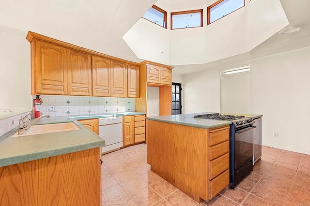 kitchen with sink, tasteful backsplash, dishwasher, a kitchen island, and black gas range